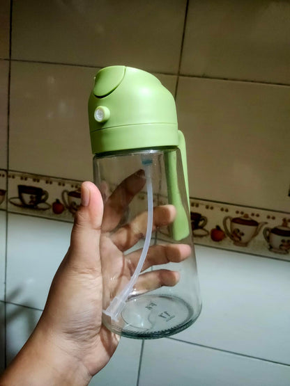 Oil spray dispenser bottle with green lid and clear straw