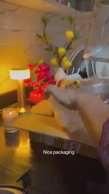 Blue Basil glass oil sprayer & pourer in use — pouring oil onto a tawa for paratha